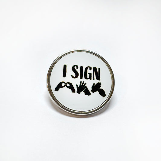 WHite BSL badge with black text that reads "I sign BSL" with finger spelling